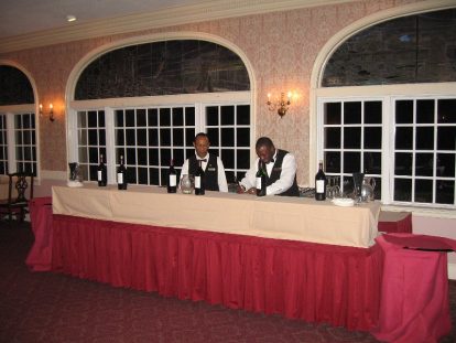 Reception staff setting up wine